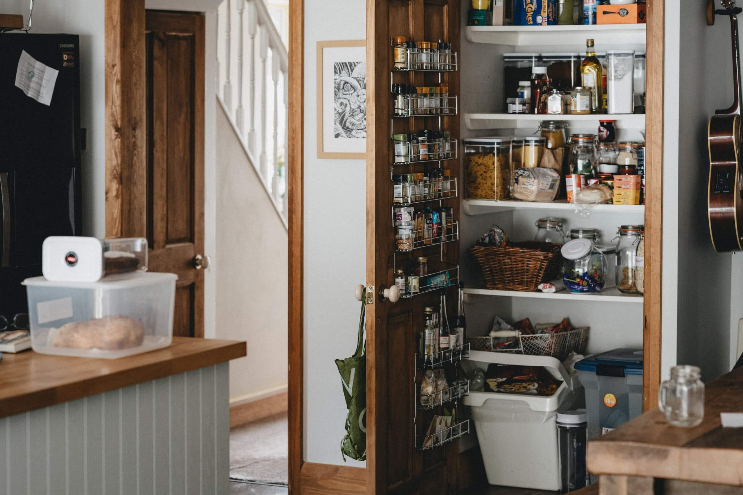 Photo of a pantry stocked with food and jars.